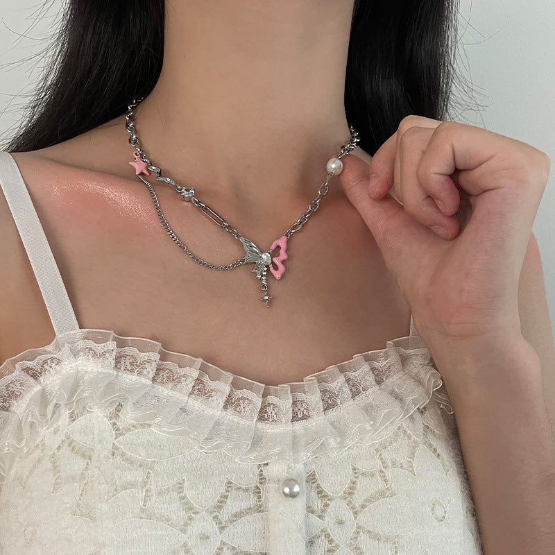 Detail shot of four-point star & pearl charms on silver Y2K choker necklace
​