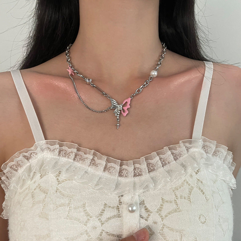 Y2K layered silver choker with pink butterfly star pearl cross pendant on female neck